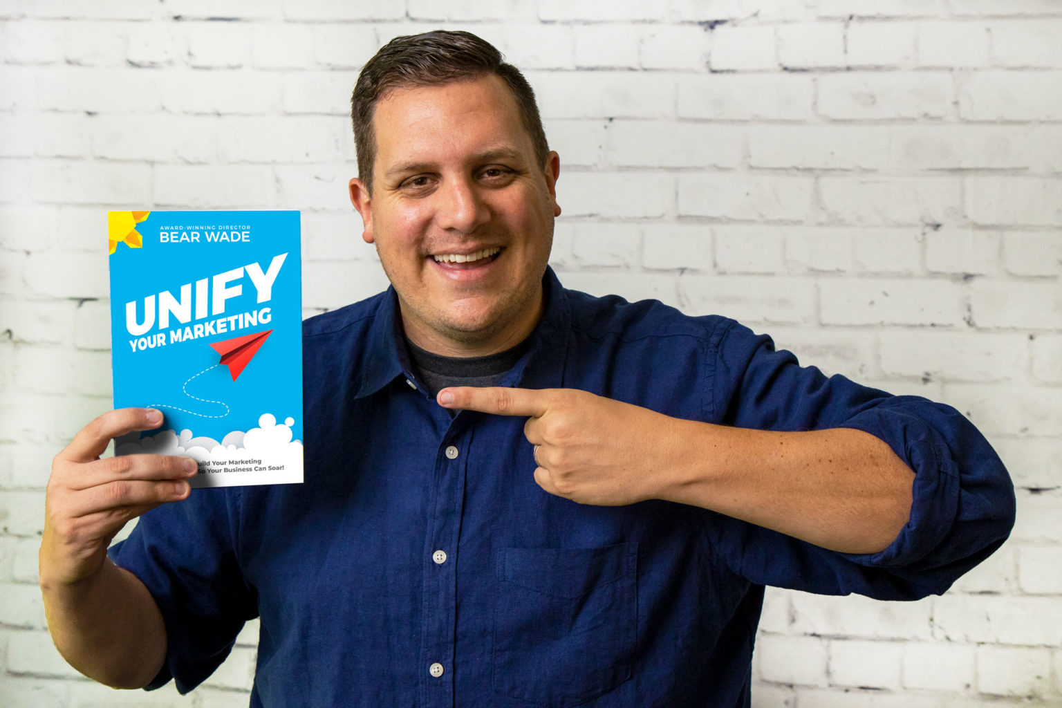 Bear Wade holding Unify Your Marketing book